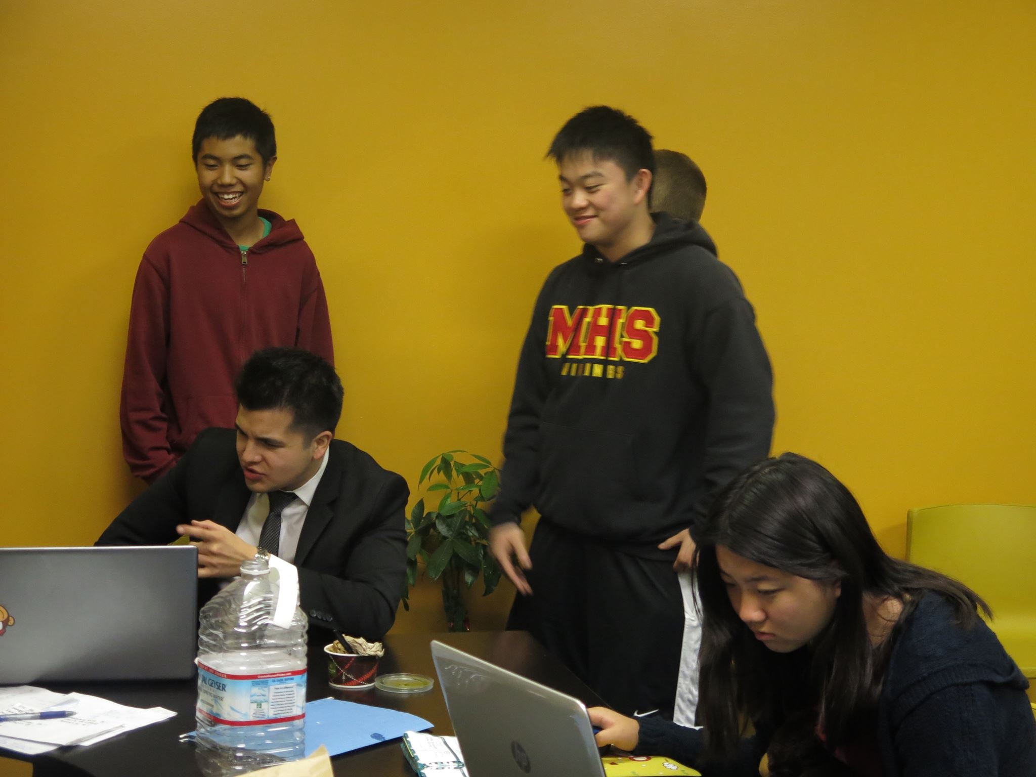 Students working with a teacher at Homework Club