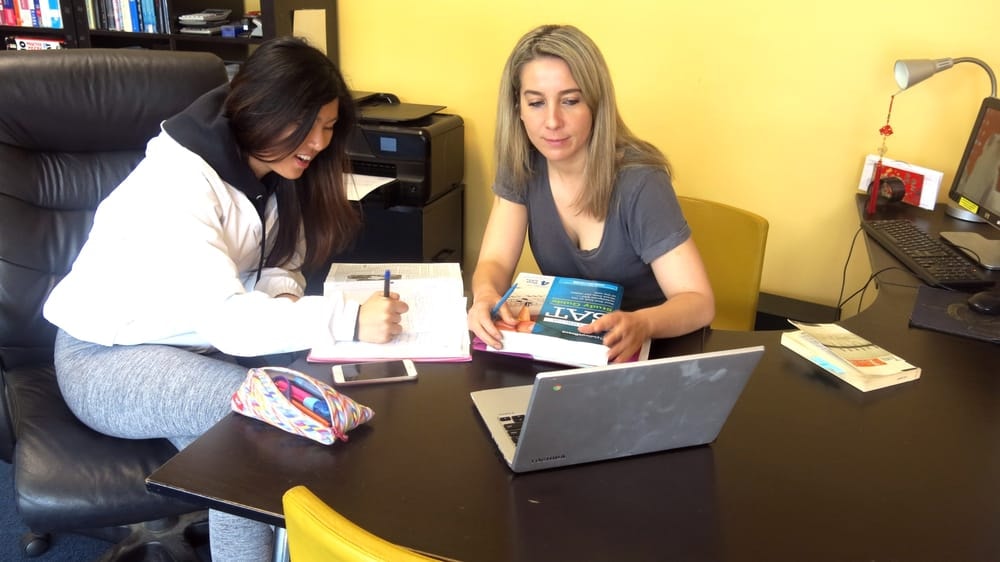 Teacher working one-on-one with a student on SAT prep